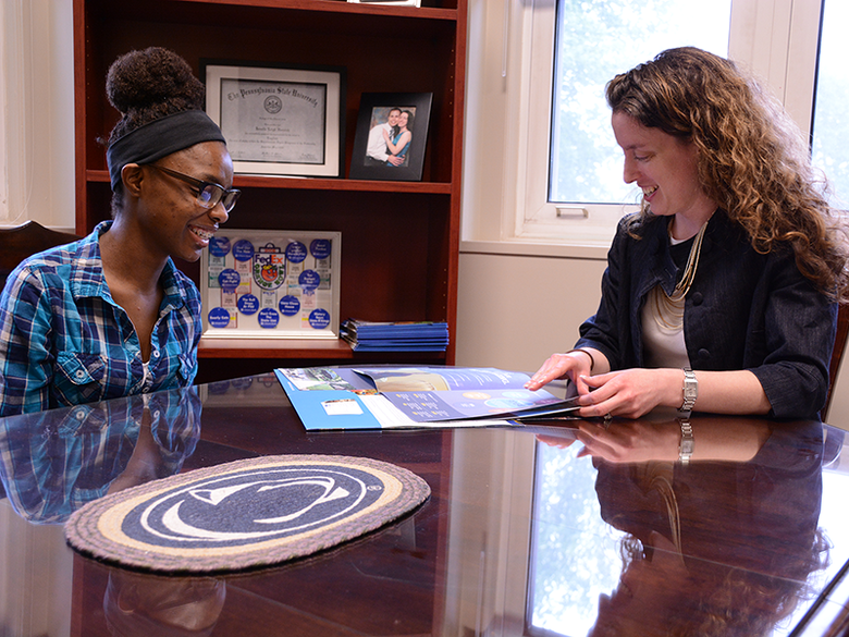 An admissions counselor discusses academic options with a prospective student.